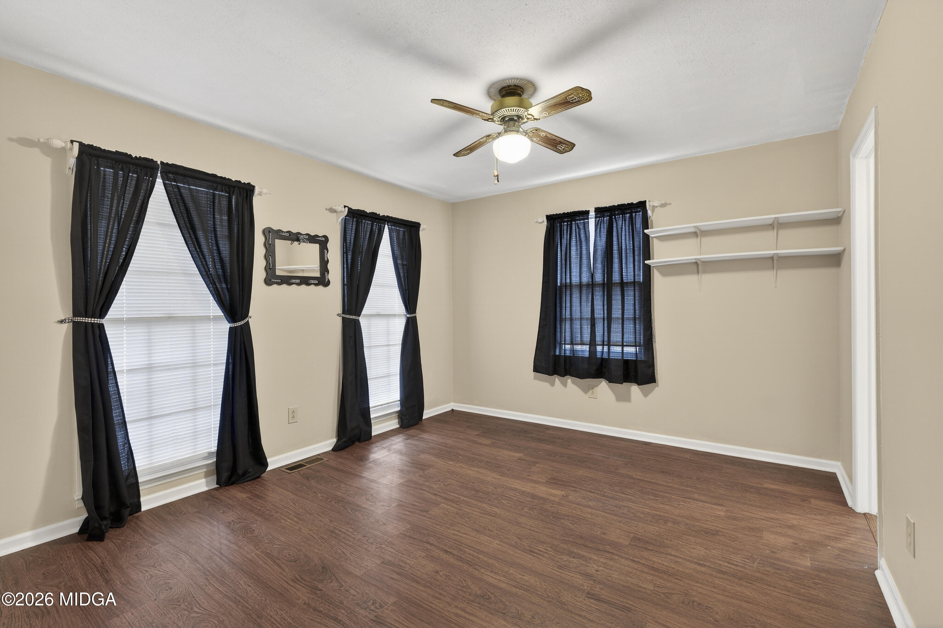 337 Highway 18 Gray, GA 31032 - Photo 32 of 50 a view of an empty room with wooden floor and a window