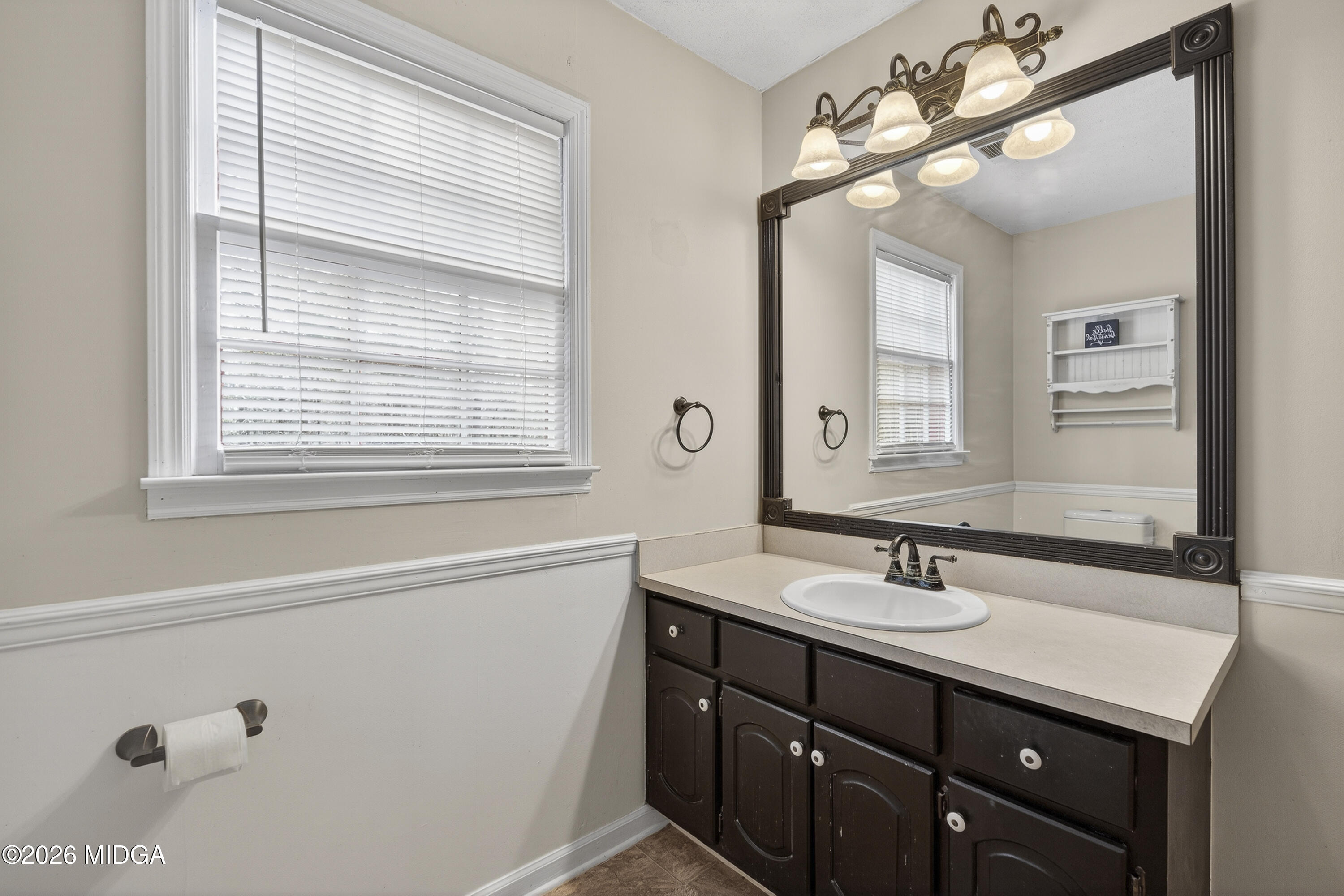 337 Highway 18 Gray, GA 31032 - Photo 41 of 50 a bathroom with a sink a vanity and a mirror