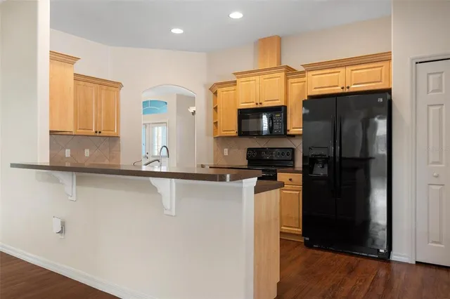 a kitchen with stainless steel appliances granite countertop a refrigerator and a sink