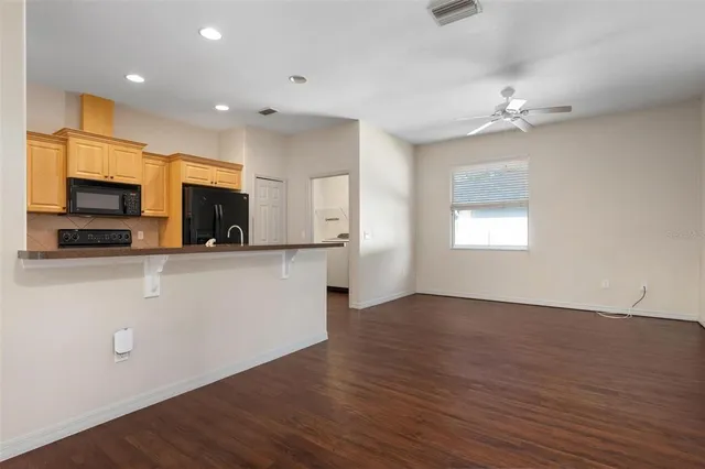 a view of a kitchen with a microwave and a stove