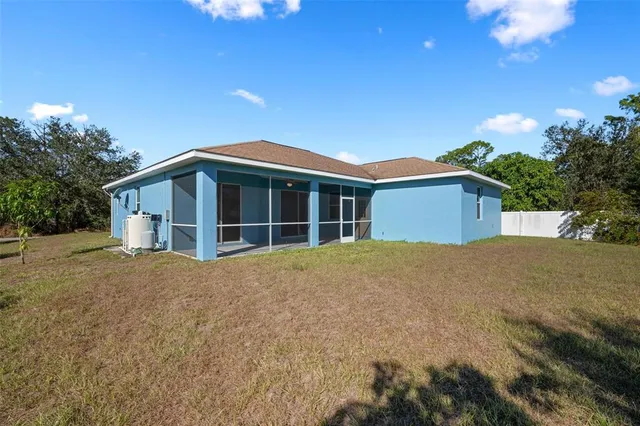 a view of a house with a backyard