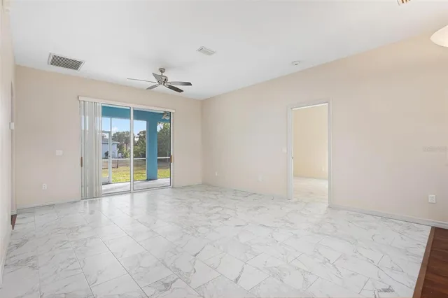 a view of an empty room with glass door