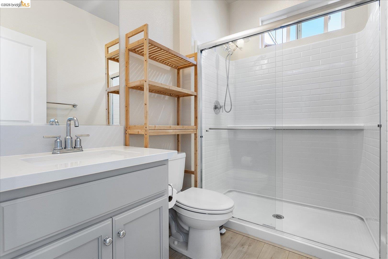 5601 Ridgepoint Way Antioch, CA 94531 - Photo 18 of 59 Bathroom featuring a light gray vanity with a white countertop and integrated sink, chrome faucet, and a large mirror