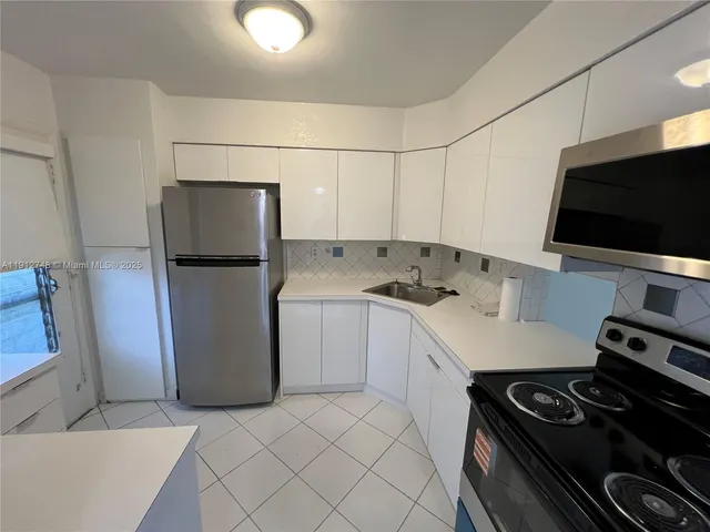 a kitchen with a microwave and a stove top oven