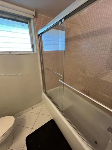 a bathroom with a sink a mirror and a shower