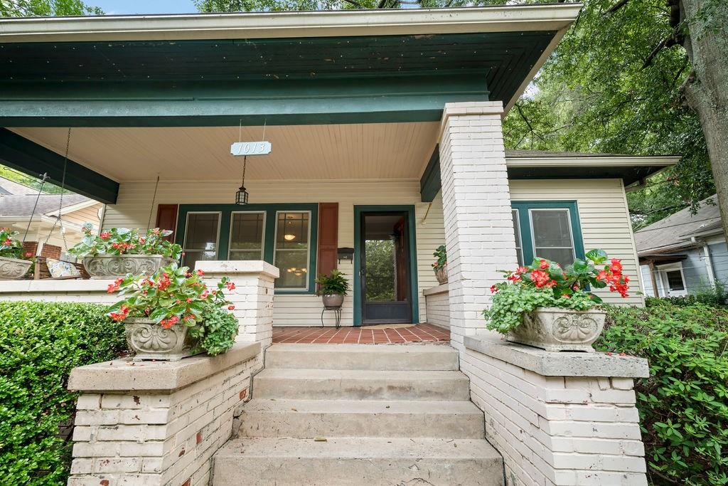 a front view of a house with plants