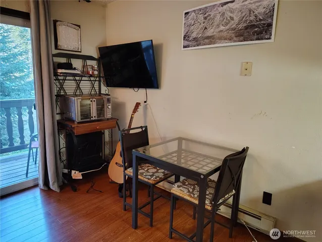 a view of a workspace with furniture and wooden floor