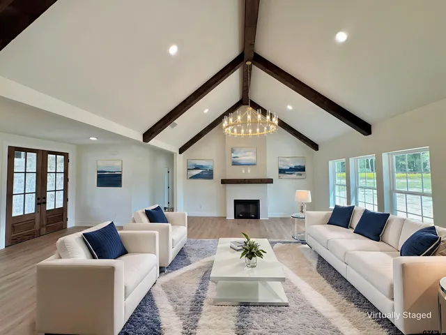 a living room with furniture couches and a fireplace