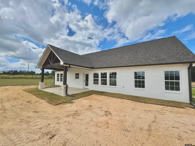 a house with pool in front of it