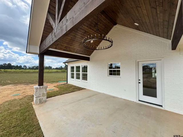 a view of a house with pool and ocean view