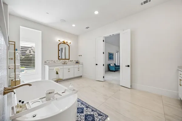 a bedroom with a bed a books bucket with wooden floor