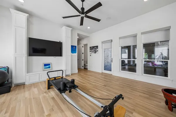 a living room with furniture kitchen view and a flat screen tv