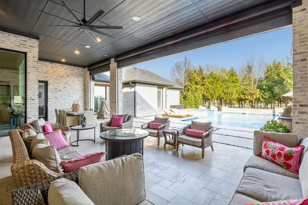 a view of a house with swimming pool and sitting area
