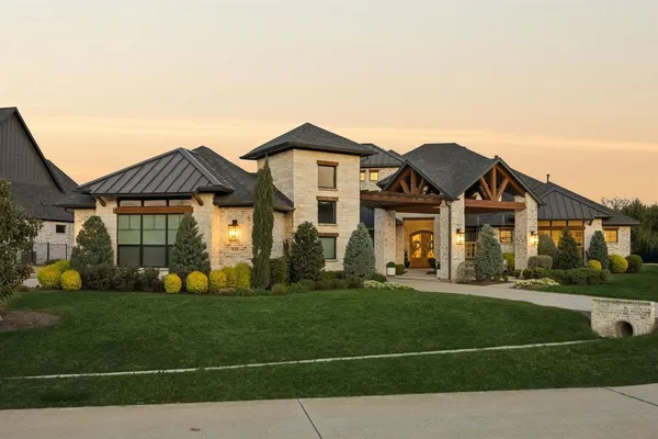 a view of a house with swimming pool and sitting area