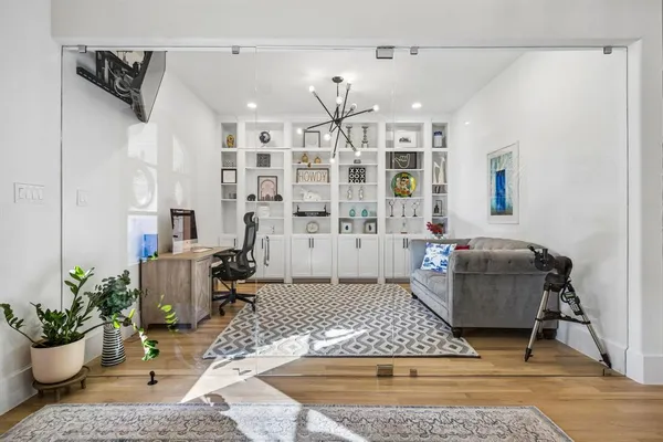 a living room with furniture and wooden floor