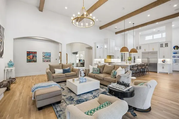 a living room with furniture chandelier and a fireplace