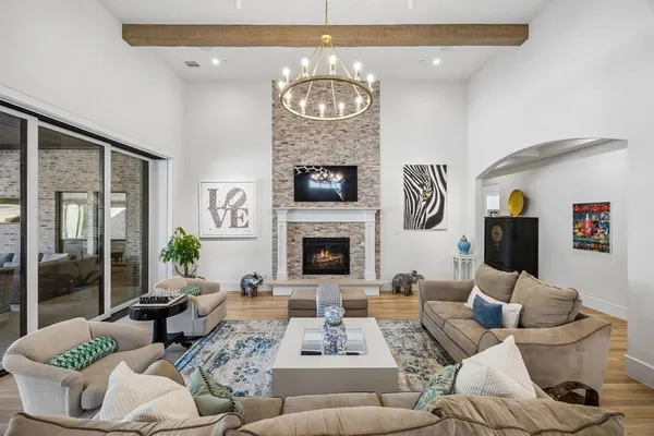 a view of living room kitchen with stainless steel appliances granite countertop furniture and a fireplace