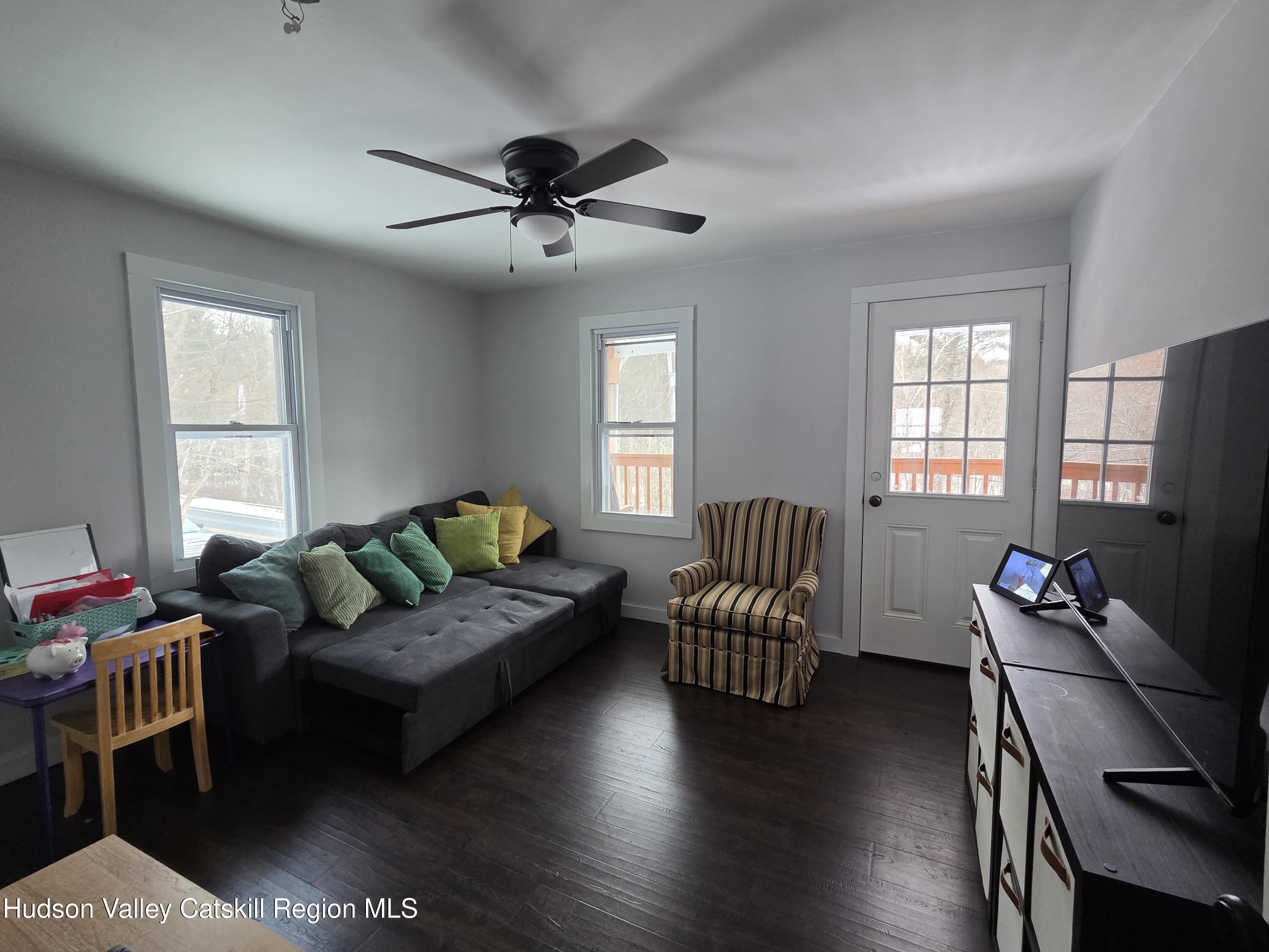 61 Cottekill Road Rosendale, NY 12419 - Photo 13 of 32 a living room with furniture a ceiling fan and a window