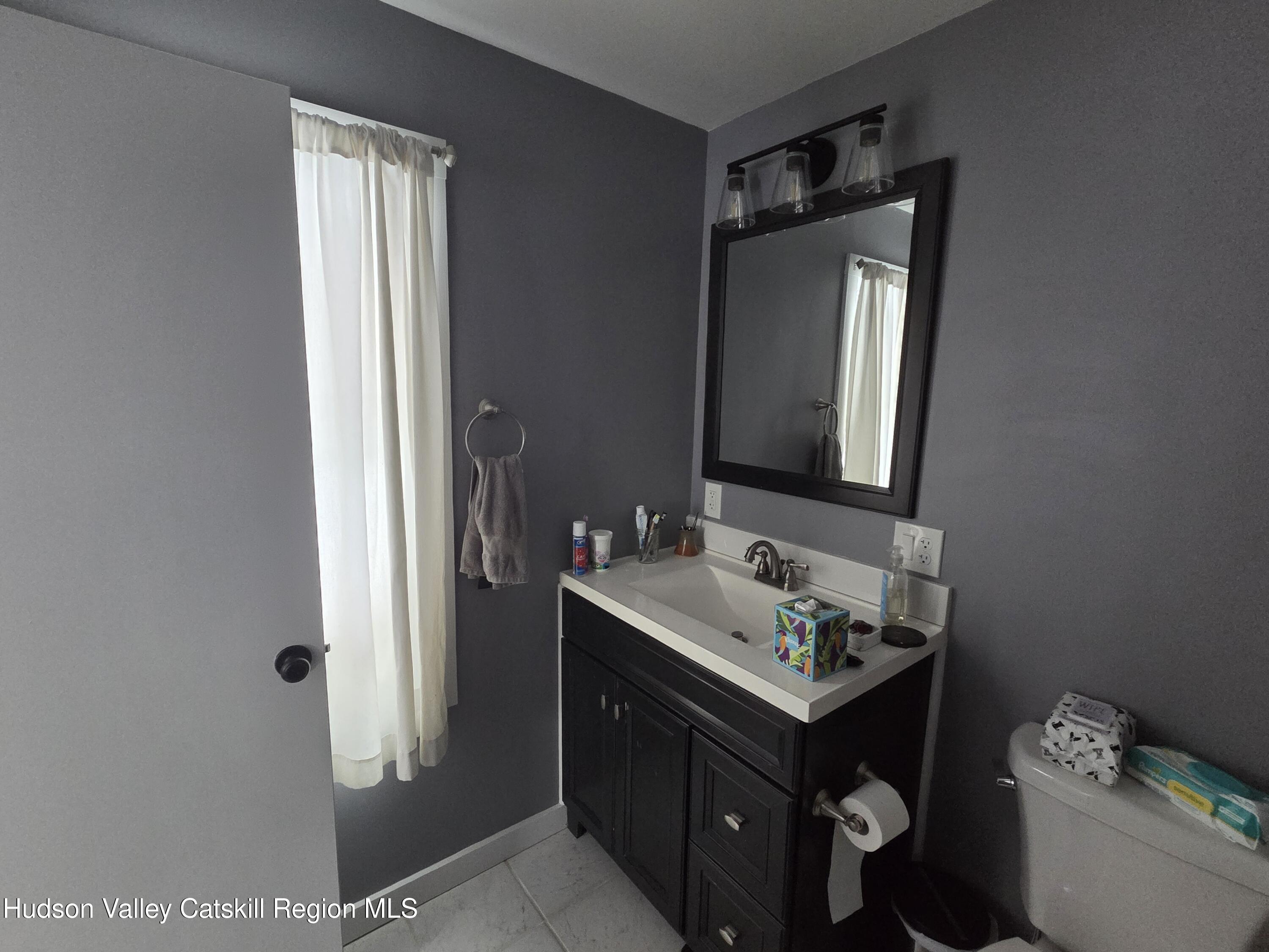 61 Cottekill Road Rosendale, NY 12419 - Photo 14 of 32 a bathroom with a sink and a mirror