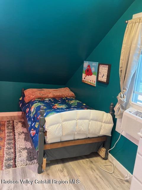 61 Cottekill Road Rosendale, NY 12419 - Photo 23 of 32 a bed sitting in a bedroom next to a window with wooden floor