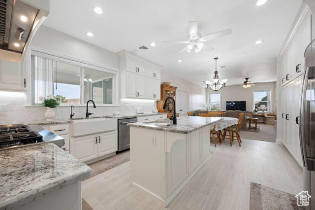230 Boulder Way Leeds, UT 84746 - Photo 8 of 72 Main Gourmet Kitchen featuring extractor fan, decorative backsplash, a center island with sink & disposal, granite stone counters, recessed lighting & overhead fan.
