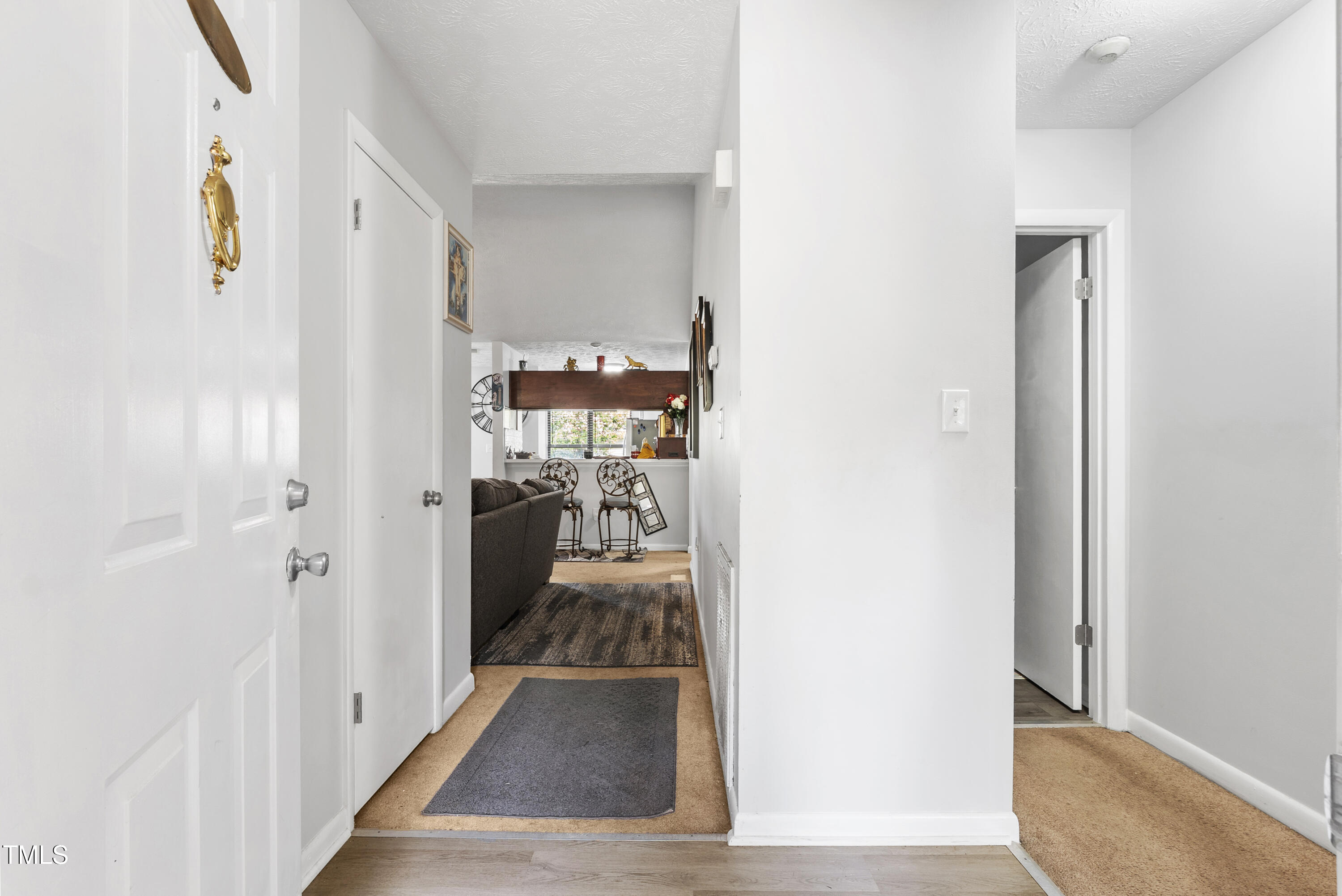 508 Duncan Road Spring Lake, NC 28390 - Photo 4 of 20 a view of a hallway with wooden floor and a living room