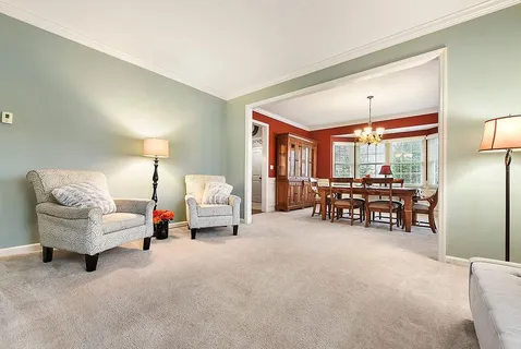 a living room with furniture and large windows