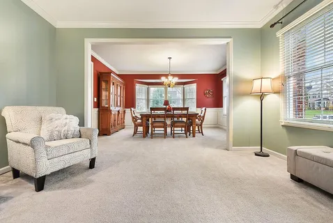 a living room with furniture and a chandelier