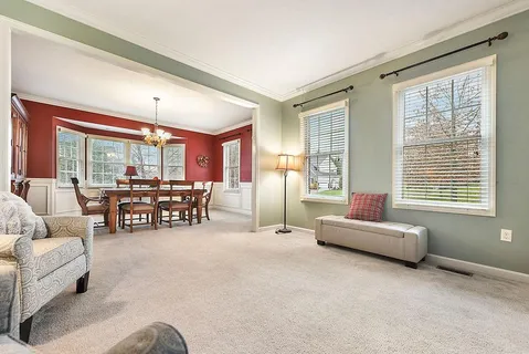 a living room with furniture and large windows