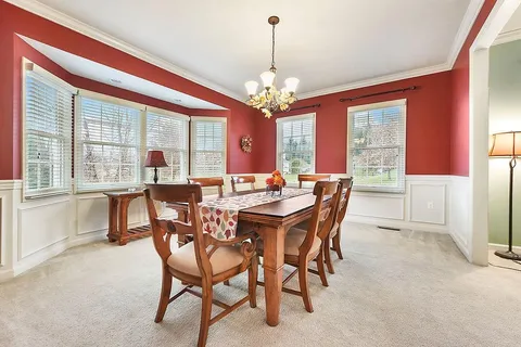 a view of a dining room with furniture window and outside view