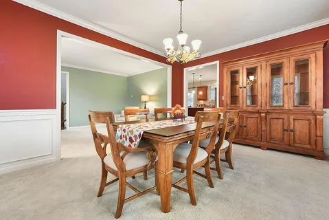 a view of a dining room with furniture and a chandelier