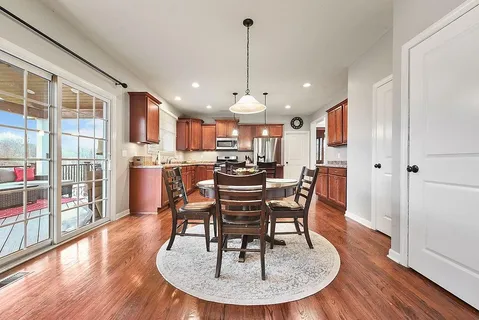 a view of a dining room with furniture window and wooden floor