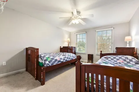 a bedroom with bed and window