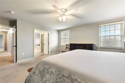 a bedroom with a large bed and a chandelier