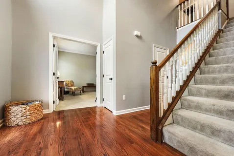 a view of a livingroom with wooden floor and furniture