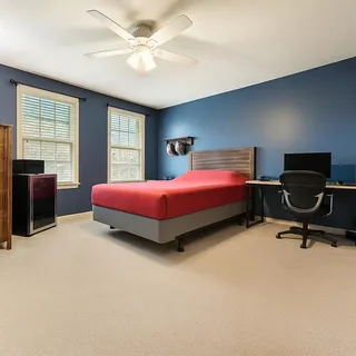 a bedroom with a bed and a desk