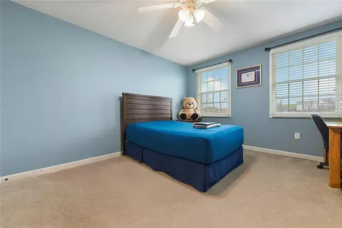a bedroom with a bed and window