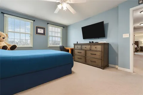 a bedroom with a bed and a flat screen tv in it