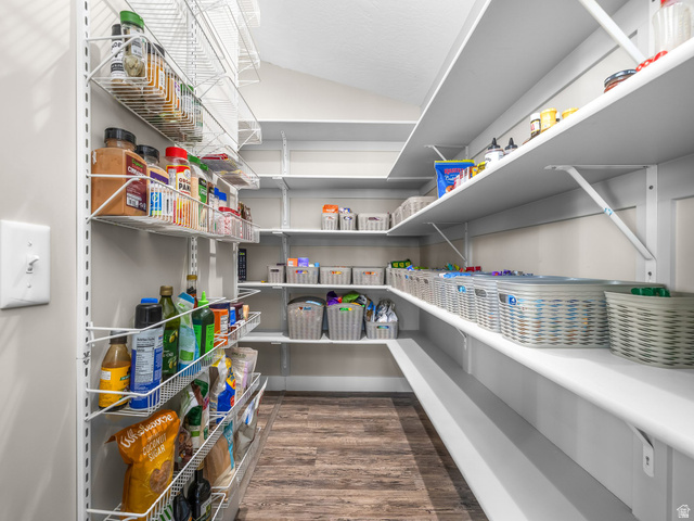 7 Sterling Loop Vineyard, UT 84059 - Photo 17 of 43 Spacious pantry featuring extensive white shelving and wire racks, wood-finish flooring, and light gray wall paint