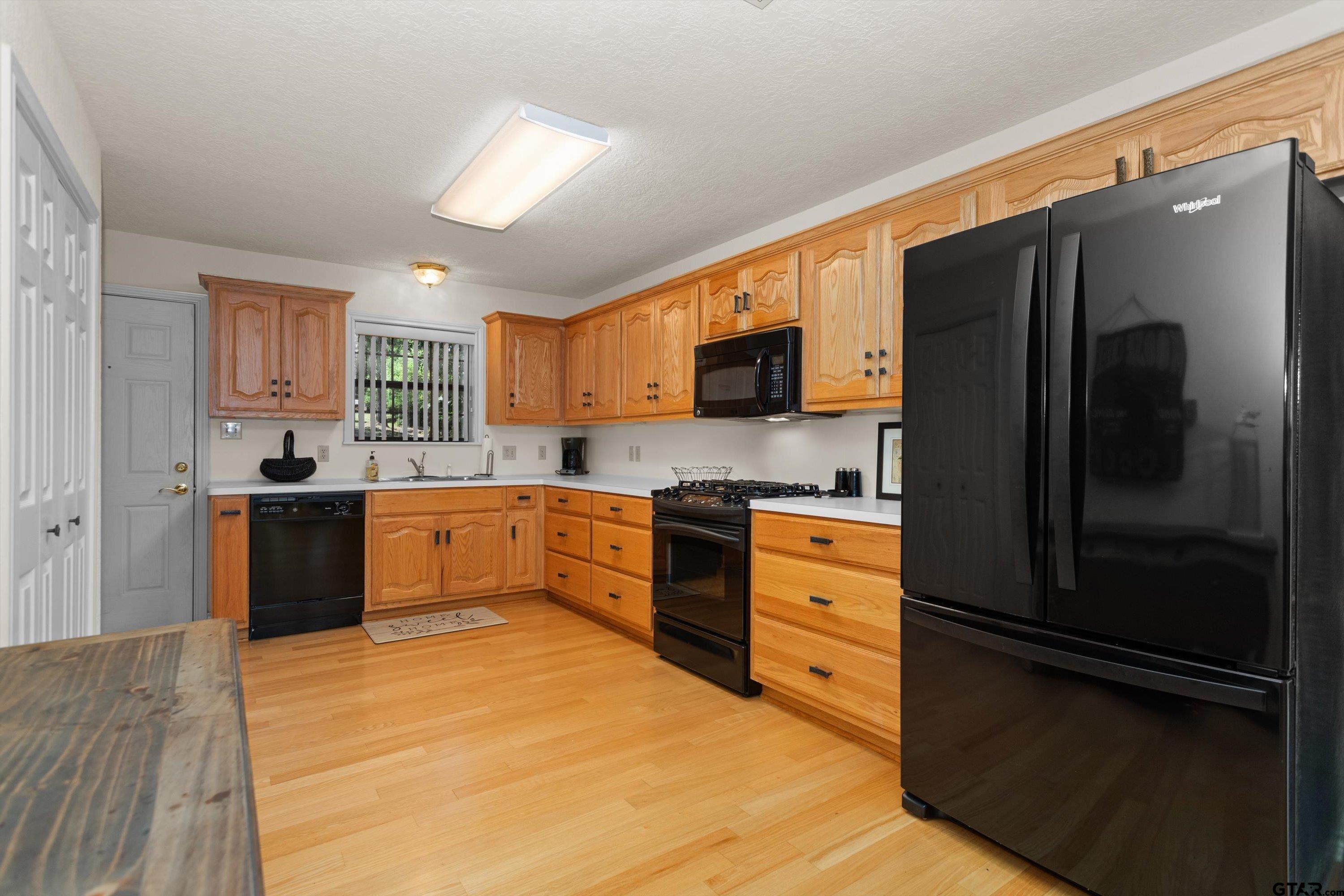 386 Dailey Road Crockett, TX 75835 - Photo 13 of 28 a kitchen with stainless steel appliances granite countertop a refrigerator sink and cabinets