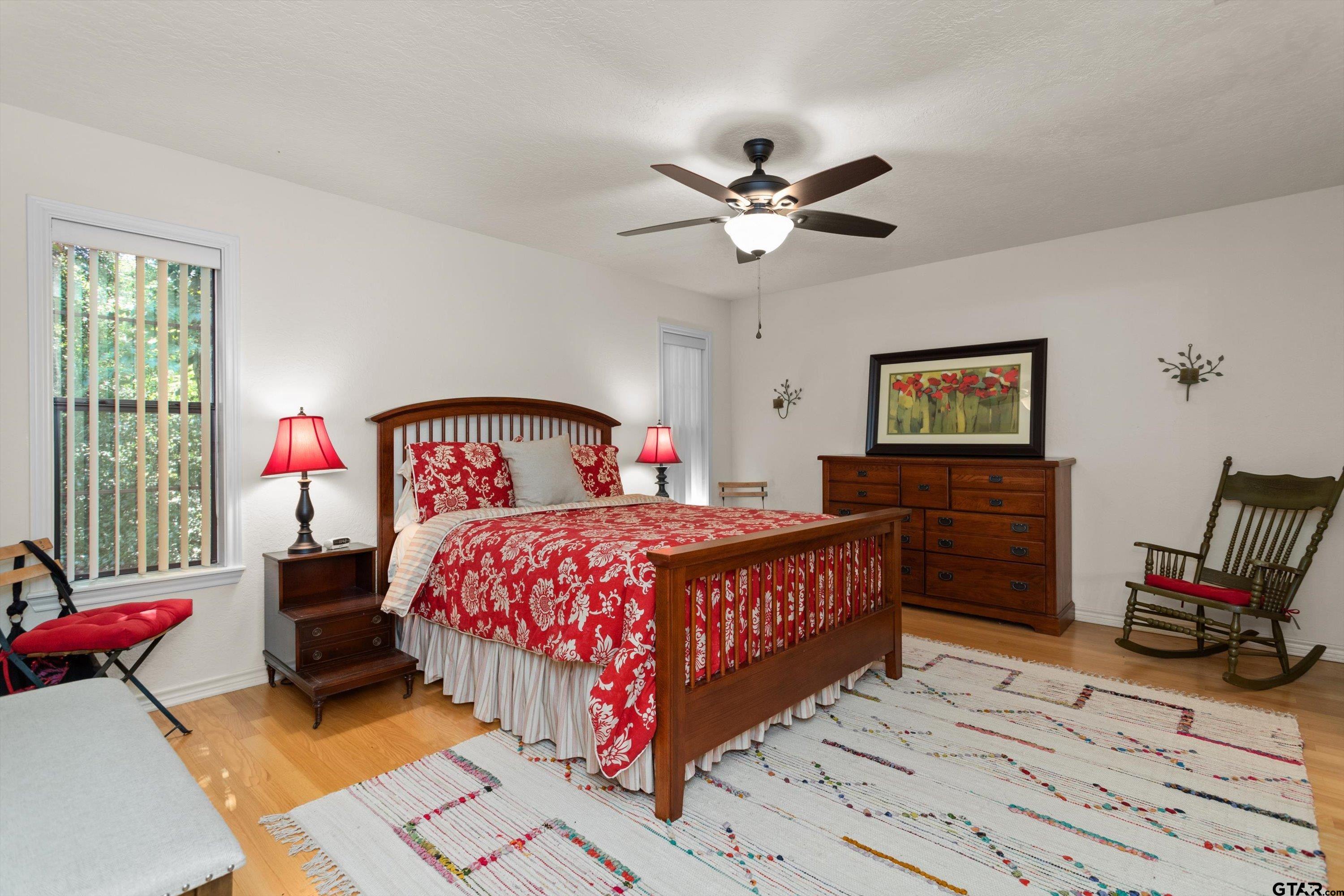 386 Dailey Road Crockett, TX 75835 - Photo 15 of 28 a bedroom with a bed wooden floor and window