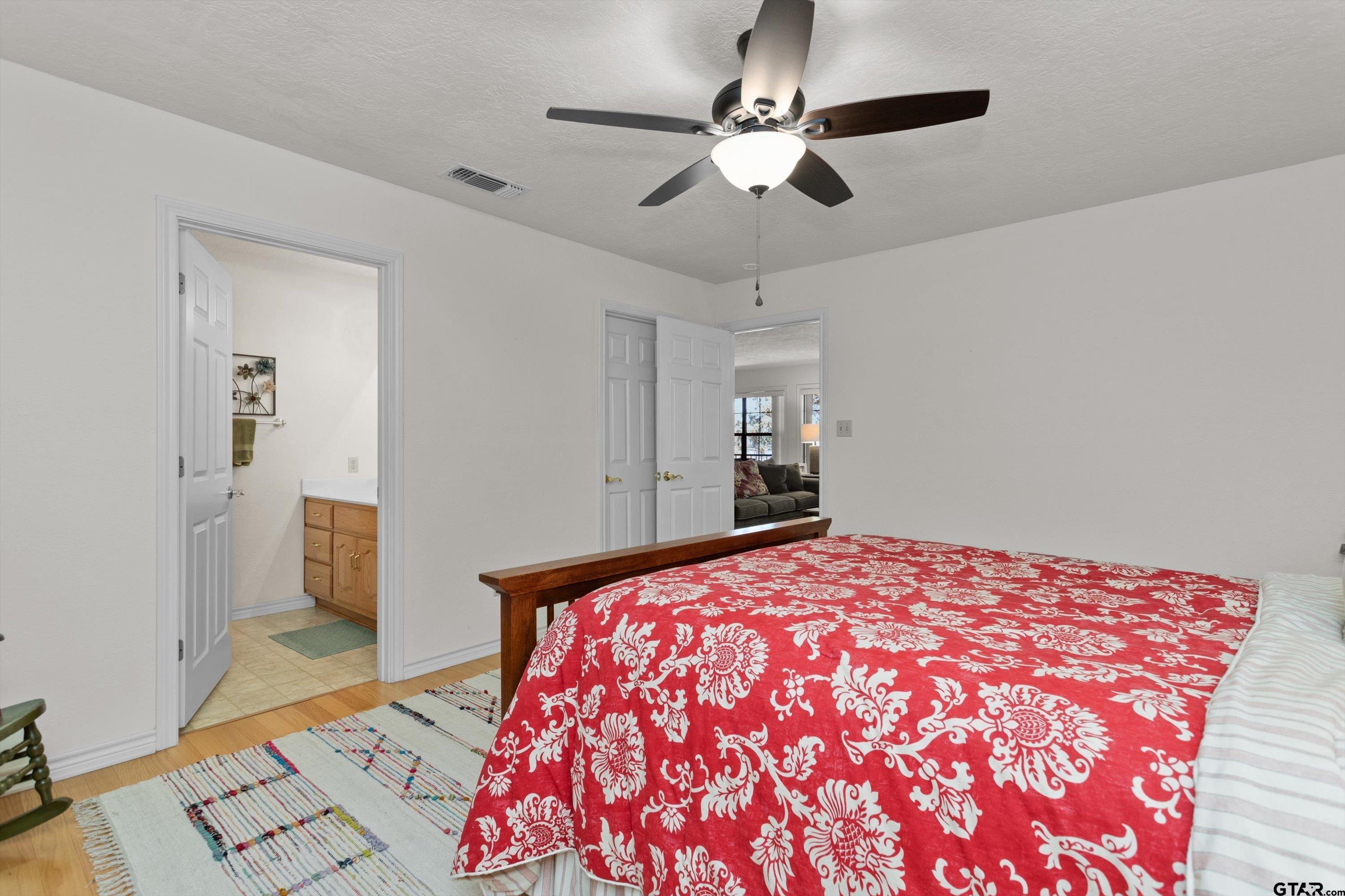 386 Dailey Road Crockett, TX 75835 - Photo 16 of 28 a bedroom with a large bed and a chandelier