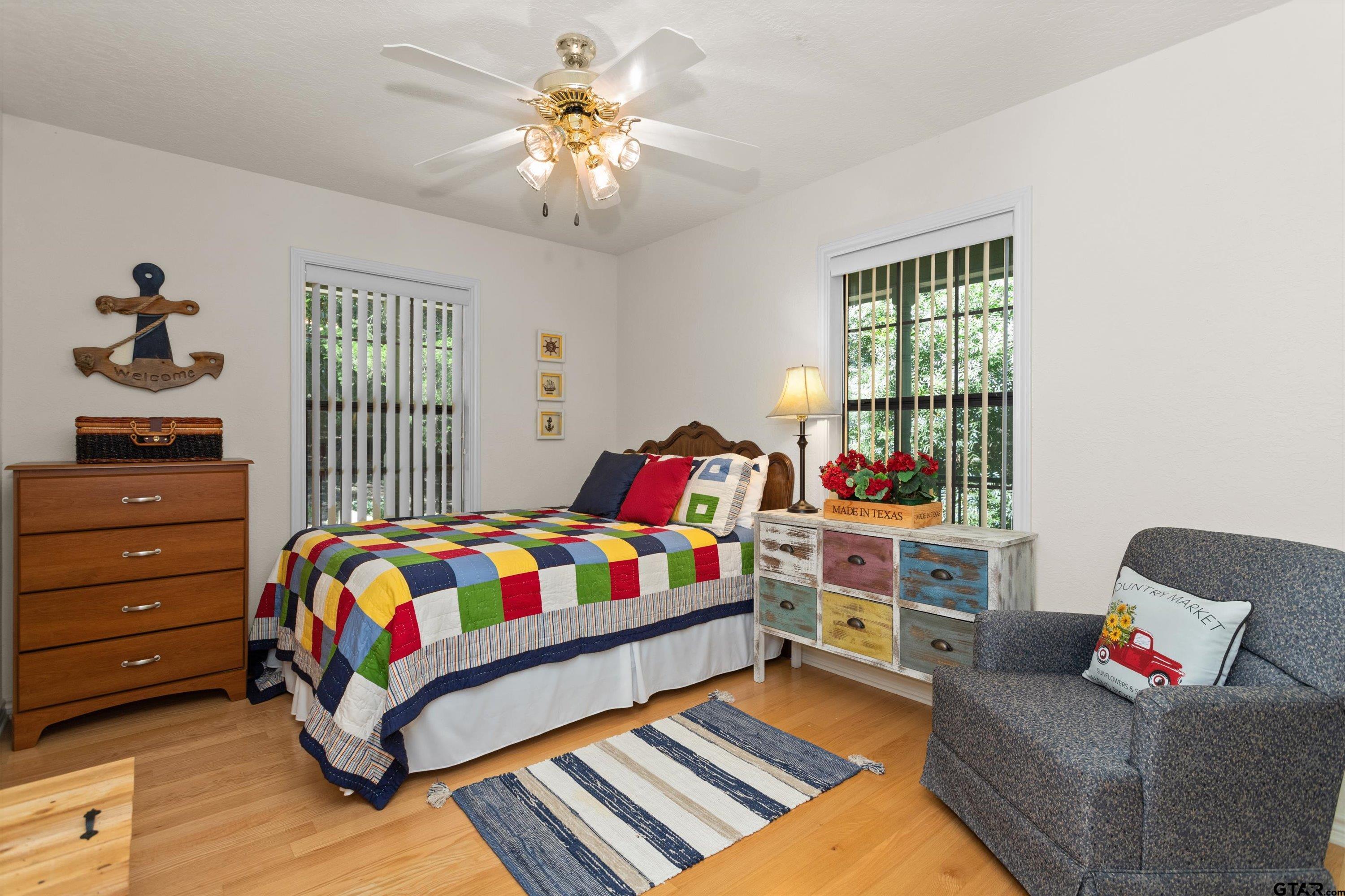 386 Dailey Road Crockett, TX 75835 - Photo 18 of 28 a bedroom with a bed and a chandelier