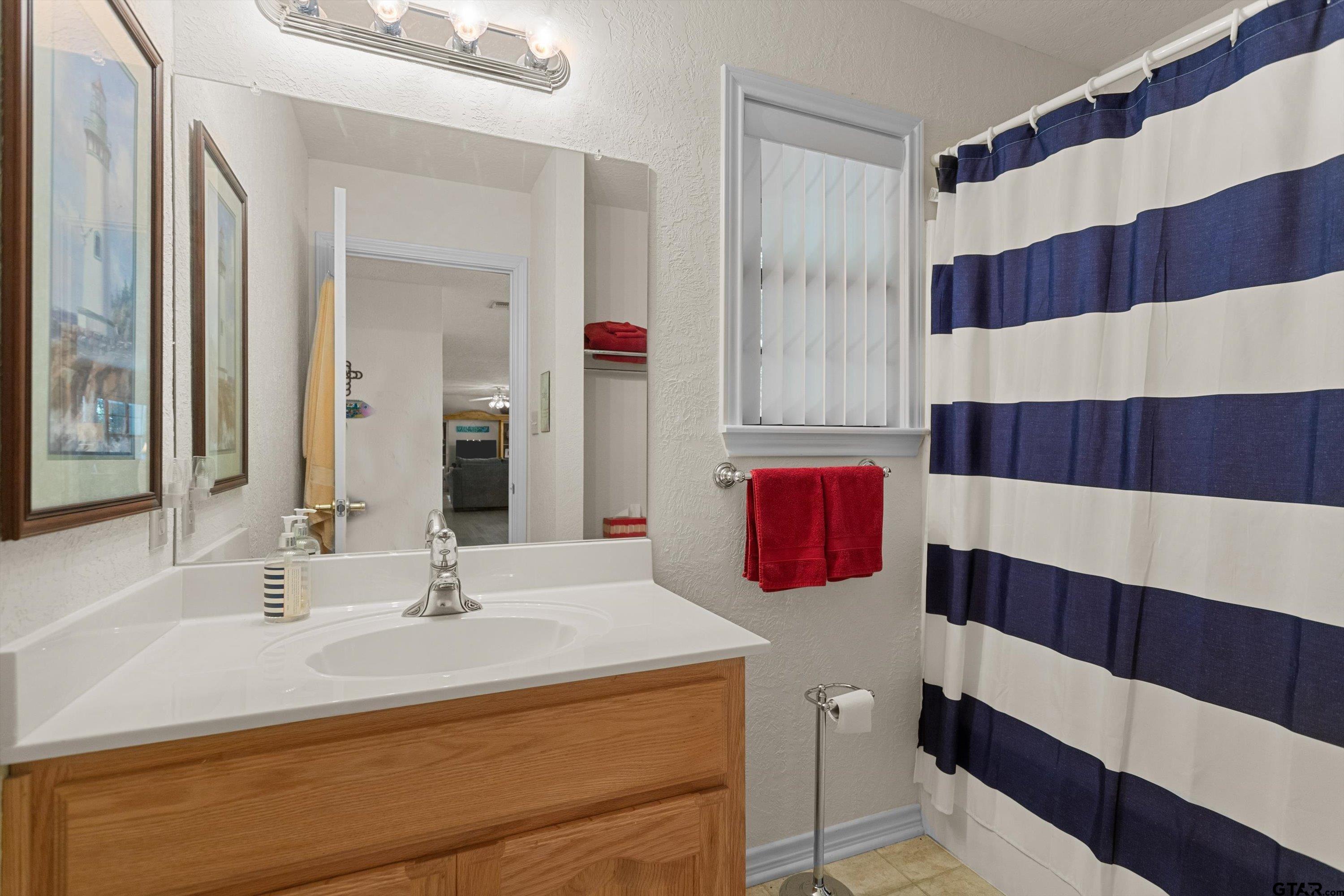 386 Dailey Road Crockett, TX 75835 - Photo 19 of 28 a bathroom with a sink and a mirror