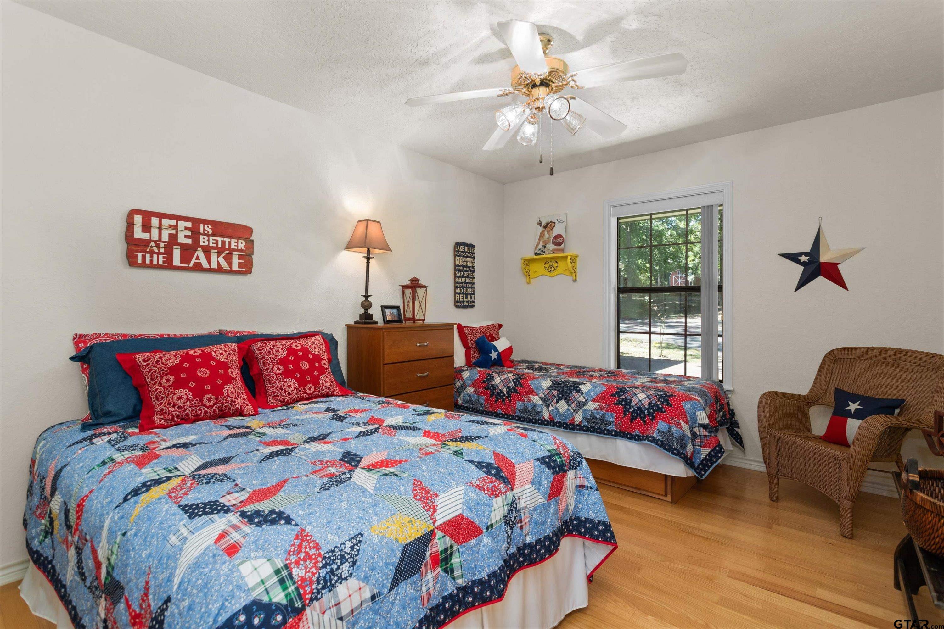 386 Dailey Road Crockett, TX 75835 - Photo 20 of 28 a bedroom with bed and a chandelier