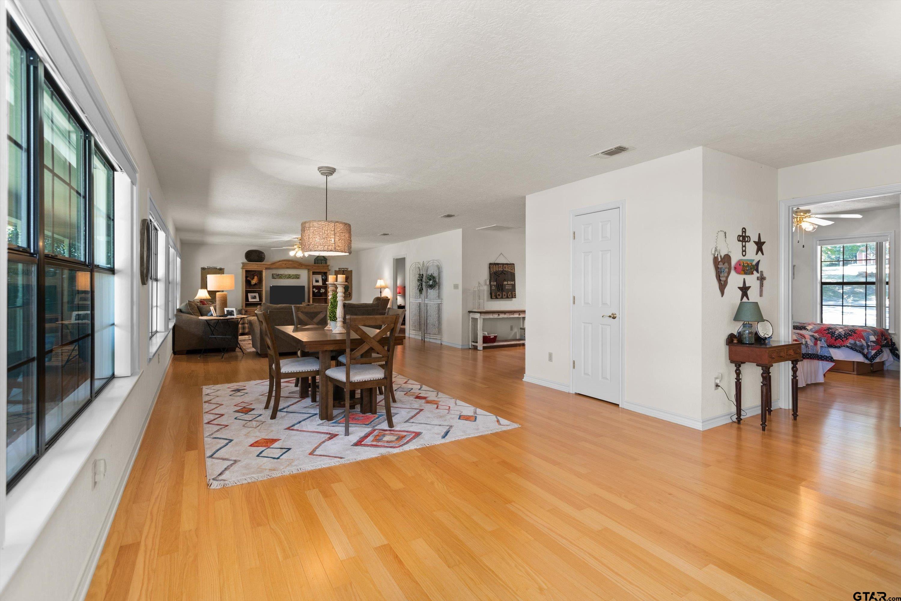 386 Dailey Road Crockett, TX 75835 - Photo 9 of 28 a living room with furniture a dining table and a fireplace