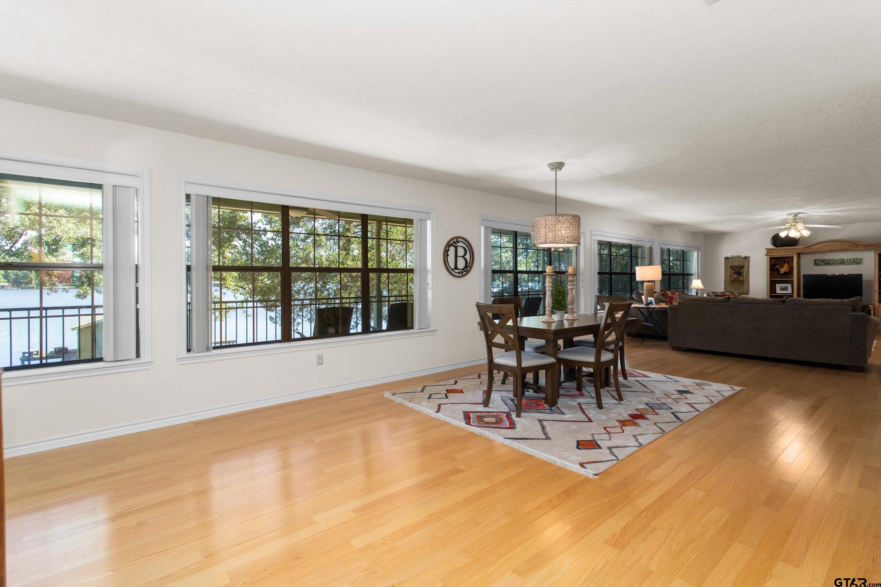 386 Dailey Road Crockett, TX 75835 - Photo 10 of 28 a dining room with furniture a chandelier and wooden floor