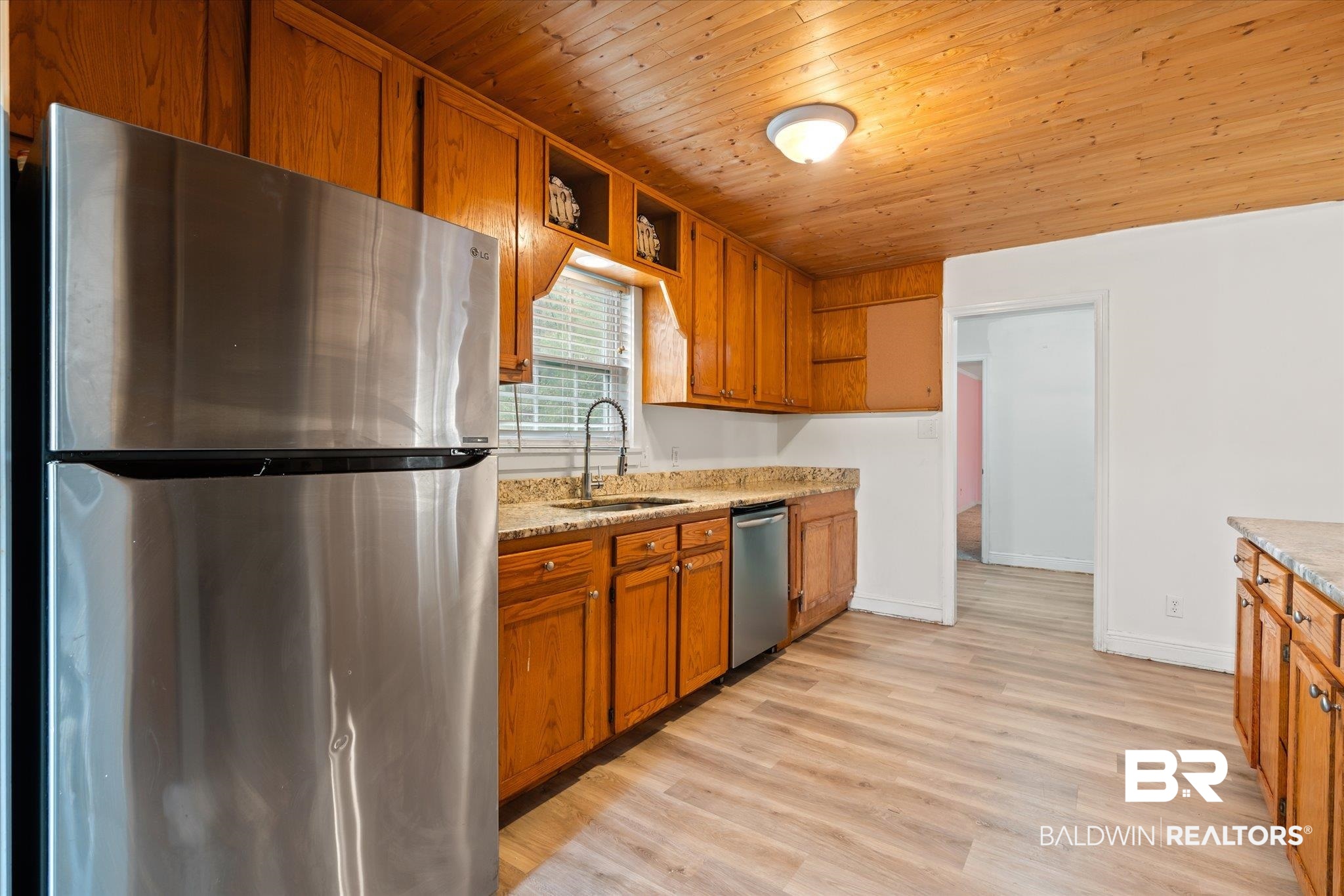 9445 Howells Ferry Road Semmes, AL 36575 - Photo 7 of 20 Kitchen featuring wood ceiling, sink, light stone countertops, light wood-type flooring, and appliances with stainless steel finishes