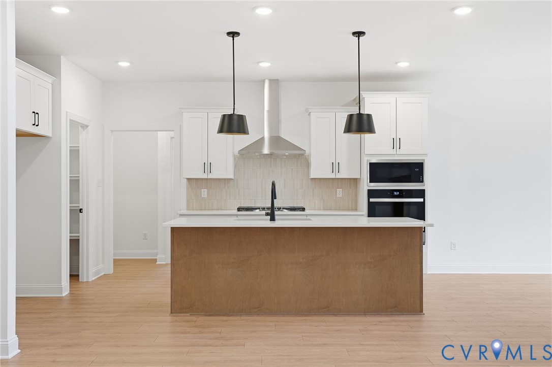 1404 Mill Quarter Road Powhatan, VA 23139 - Photo 11 of 29 a large kitchen with stainless steel appliances kitchen island a large stove a sink a refrigerator and a microwave