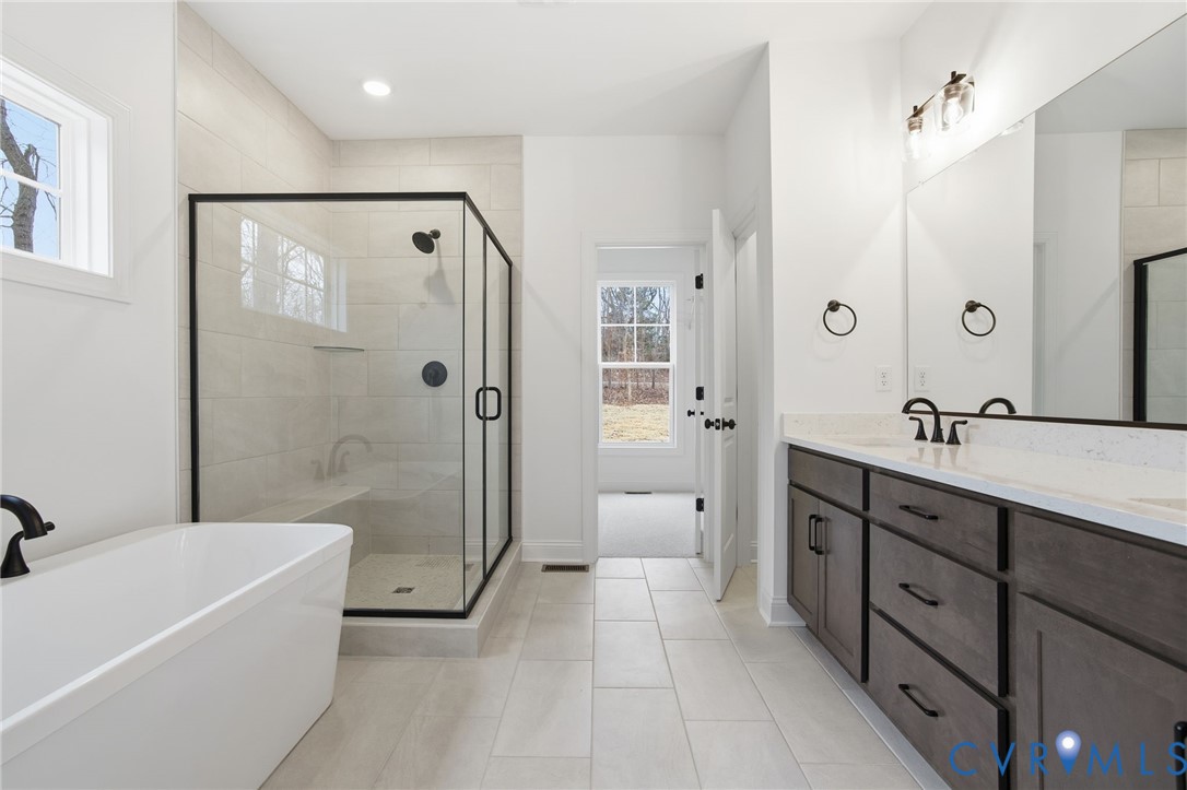 1404 Mill Quarter Road Powhatan, VA 23139 - Photo 16 of 29 a spacious bathroom with a tub sink shower and mirror